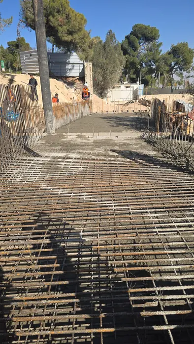 פריסת רשת זיון על שטח נרחב לפני יציקת משטח בפארק.